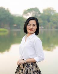 A person standing in front of a body of water

Description automatically generated